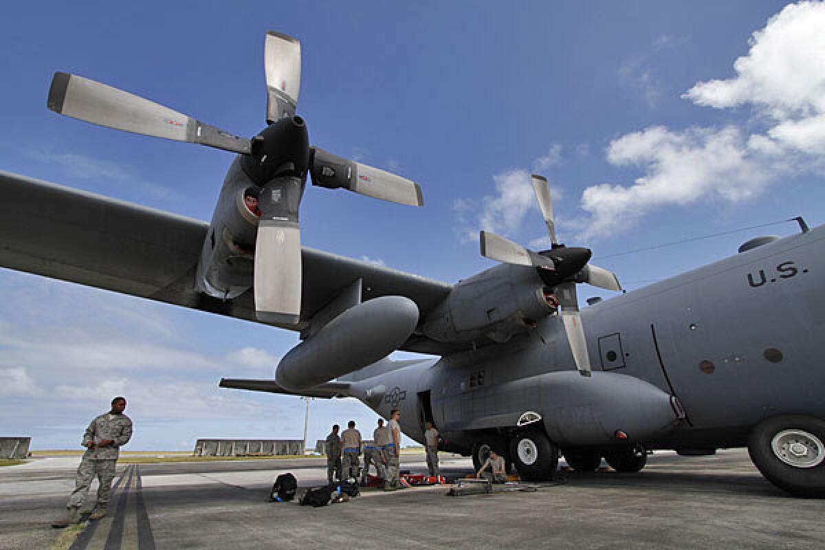 Members of the 374th Airlift Wing of the U.S. Air Force work on a C-130 aircraft in February during military exercises at Andersen Air Force Base on Guam.