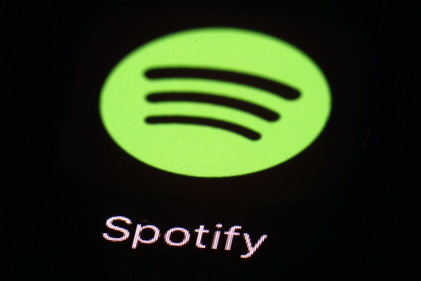 FILE- This March 20, 2018 file photo shows the Spotify app on an iPad in Baltimore. Music streaming service Spotify says it's cutting 6% of its workforce, becoming yet another tech company resorting to layoffs as the economic outlook worsens. CEO Daniel Ek announced the restructuring in a message to employees that was also posted online Monday, Jan. 23, 2023. (AP Photo/Patrick Semansky, File)