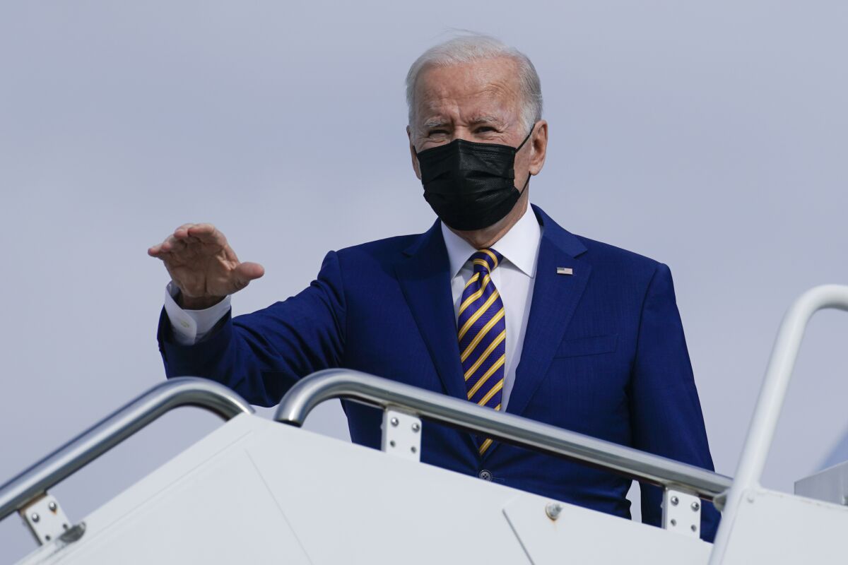 President Biden waves as he boards Air Force One at Joint Base Andrews in Maryland on Nov. 30.