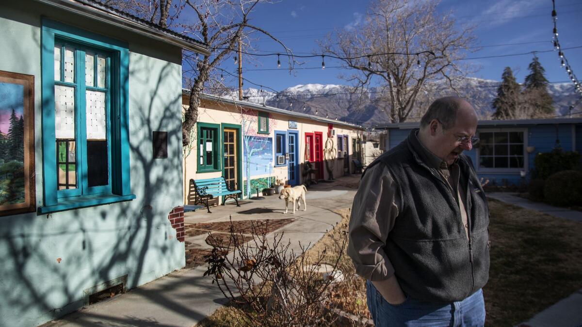 David Blacker, president of the Lone Pine Chamber of Commerce, stands in the courtyard area of the chamber which is headquartered in a former hotel.