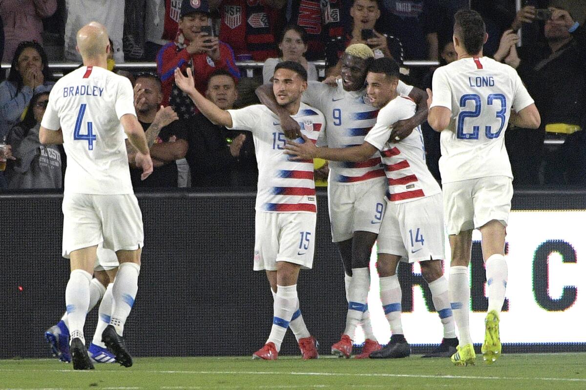 U.S. forward Gyasi Zardes (9) is congratulated by teammates after scoring the game's only goal in a 1-0 victory over Ecuador in Orlando, Fla.