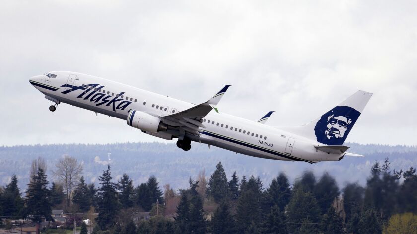 An Alaska Airlines jet takes off at Seattle-Tacoma International Airport. LGBT leaders are calling for a boycott of the airline following an incident involving a gay couple flying from New York to Los Angeles.