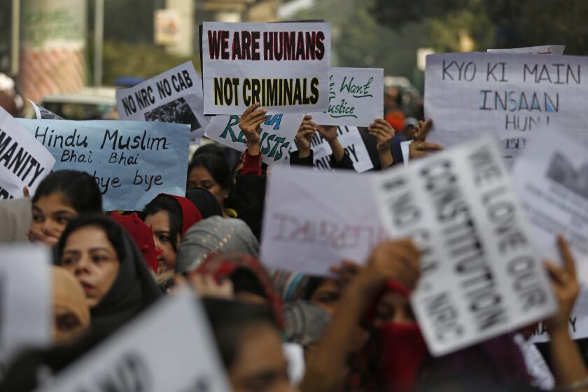 Indian students of the Jamia Millia Islamia University hold placards as they march during a protest against a new citizenship law, in New Delhi, India, Wednesday, Dec. 18, 2019. India’s Supreme Court on Wednesday postponed hearing pleas challenging the constitutionality of the new citizenship law that has sparked opposition and massive protests across the country. (AP Photo/Altaf Qadri)