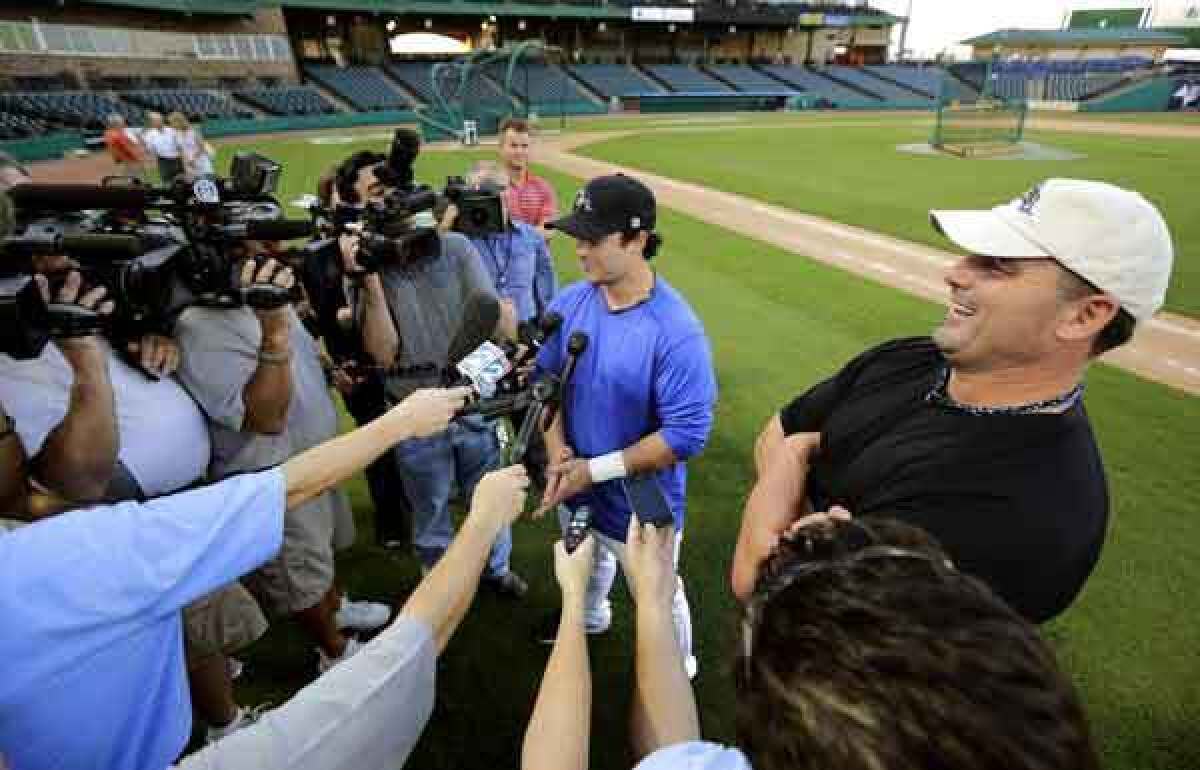 Roger Clemens and son Koby field questions from reporters during a news conference in Sugar Land, Texas.