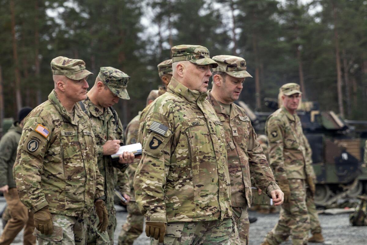 U.S. Army Gen. Mark A. Milley, center, and other men in camouflage fatigues