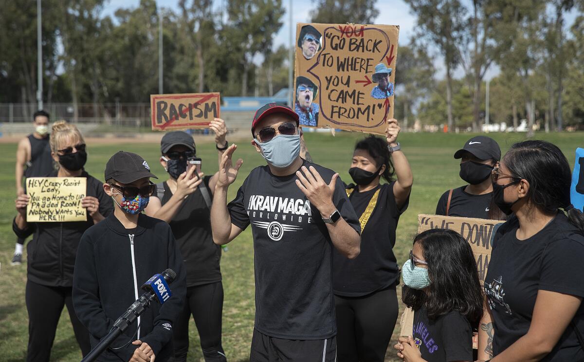Protesters gather at Charles H. Wilson Park in Torrance to condemn an anti-Asian rant against a parkgoer.