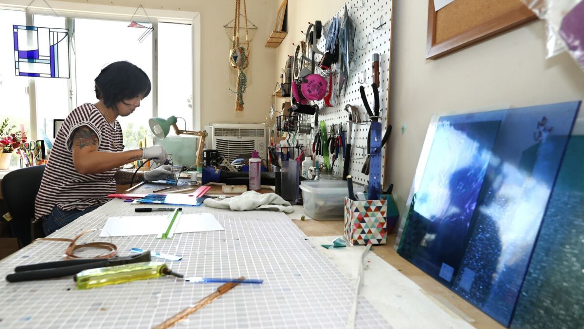 Janel Foo solders pieces of glass together in her Highland Park studio.