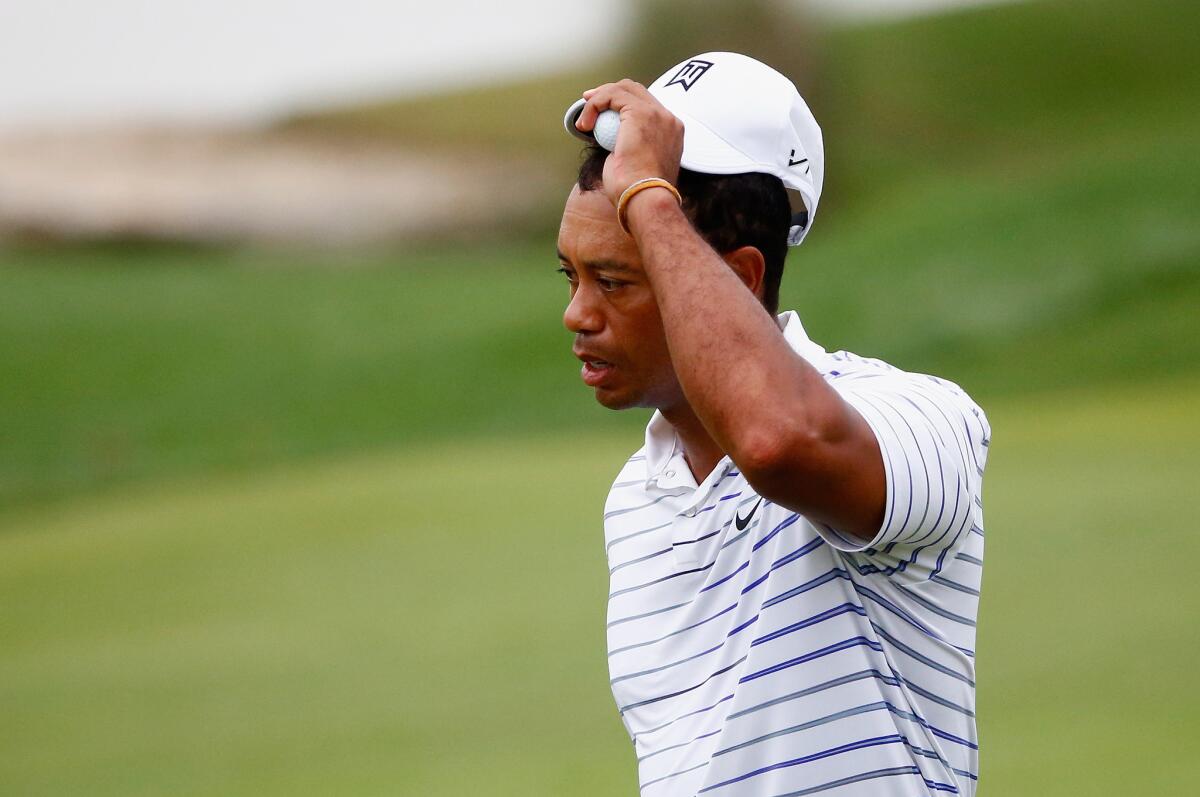 Tiger Woods tips his cap after playing the 18th hole during the second round of the PGA Championship on Aug. 8. He struggled in the tournament.