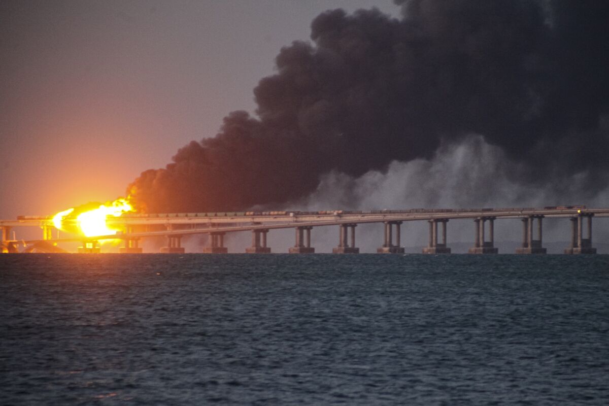 Flames and smoke rise from Crimean Bridge connecting Russian mainland and Crimean peninsula