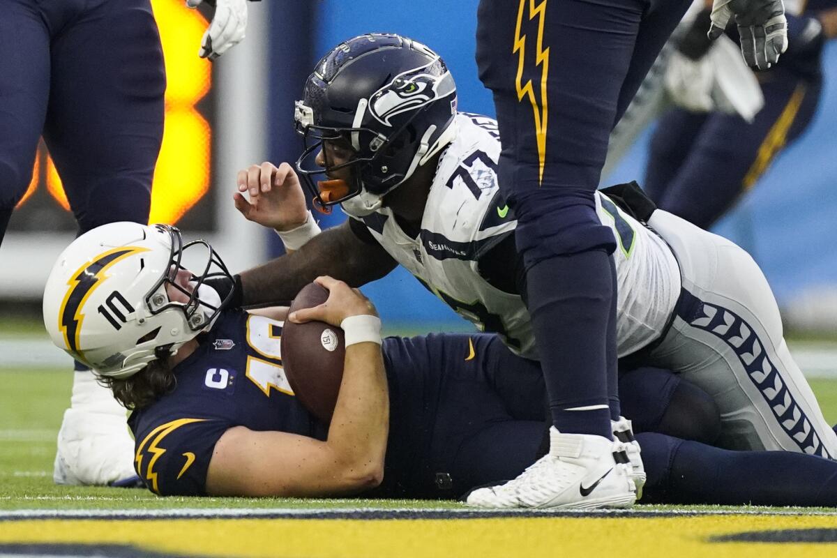 Chargers quarterback Justin Herbert is sacked by Seattle Seahawks defensive tackle Quinton Jefferson.
