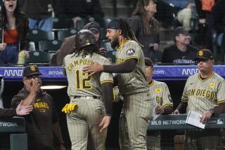 San Diego Padres' Fernando Tatis Jr., center right, congratulates Luis Campusano (12) after Campusano scored on a double hit by pinch hitter Tyler Wade off Colorado Rockies relief pitcher Nick Mears in the eighth inning of a baseball game Monday, April 22, 2024, in Denver. (AP Photo/David Zalubowski)