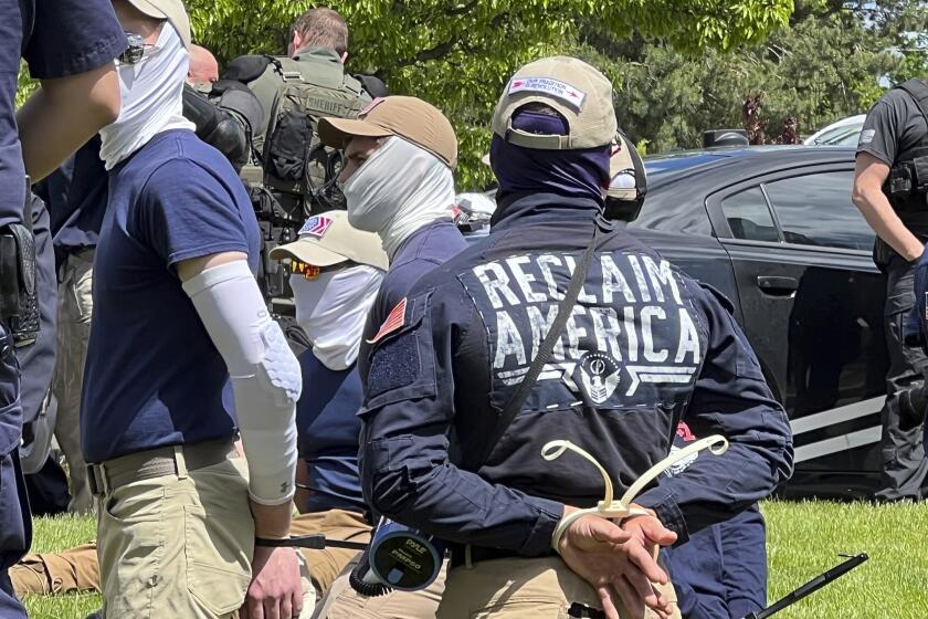 Authorities arrest members of the white supremacist group Patriot Front near an Idaho pride event Saturday, June 11, 2022, after they were found packed into the back of a U-Haul truck with riot gear. (Georji Brown via AP)