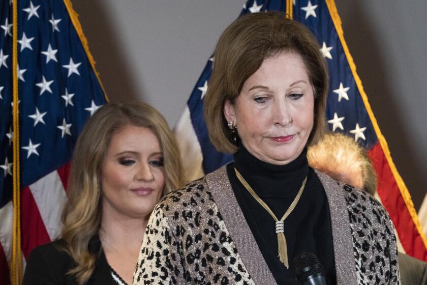 Members of President Donald Trump's legal team, Sidney Powell, right, with Jenna Ellis, left, attend a news conference at the Republican National Committee headquarters, Thursday Nov. 19, 2020, in Washington. (AP Photo/Jacquelyn Martin)