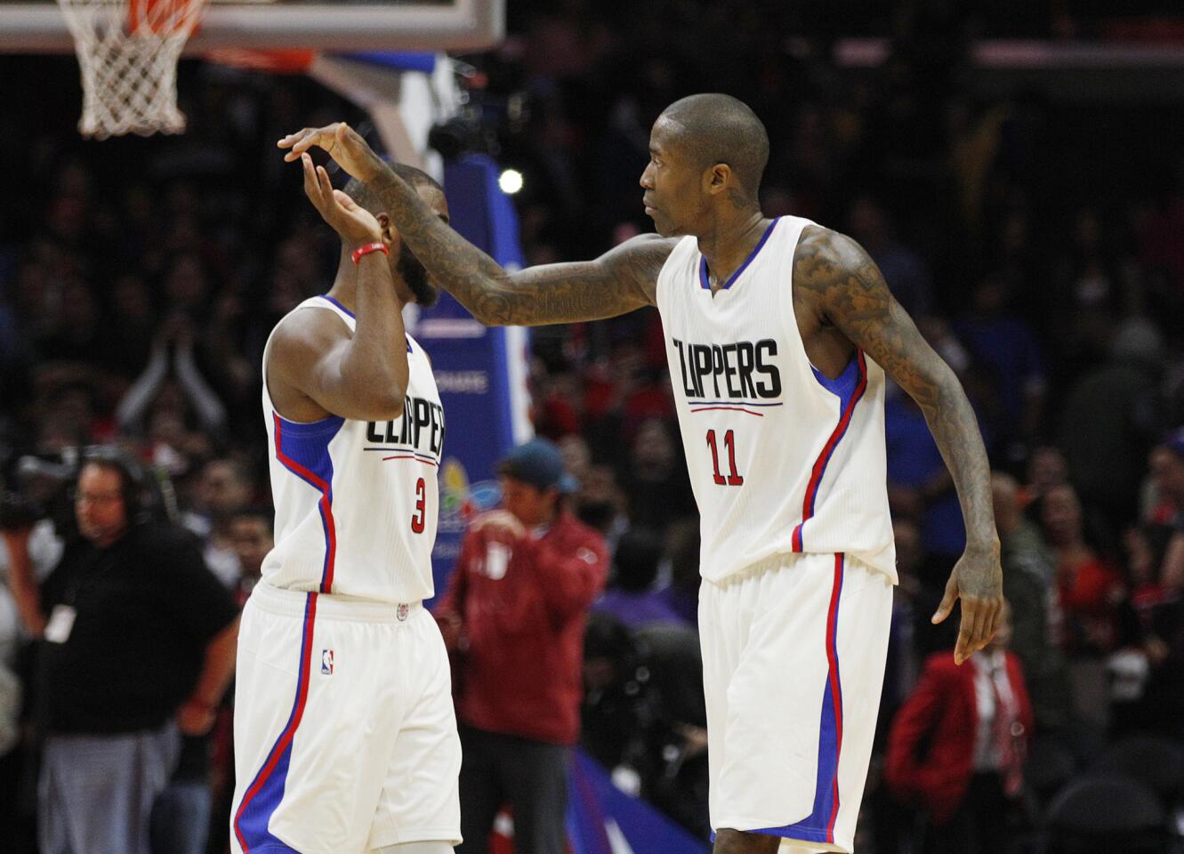 Clippers guards Chris Paul (3) and Jamal Crawford (11) celebrate after defeating the Charlotte Hornets, 97-83, on Saturday afternoon at Staples Center.
