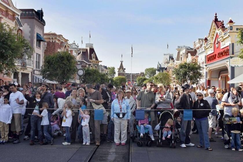 Crowds wait to enter Disneyland. Attendance at all domestic Disney parks rose 7% in the three-month period that ended Dec. 27.