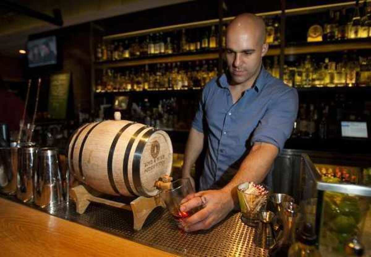 Mess Hall Kitchen bartender Erik Lund pours a barrel-aged Smith & Cross Jamaican rum, which has a proof of 114.