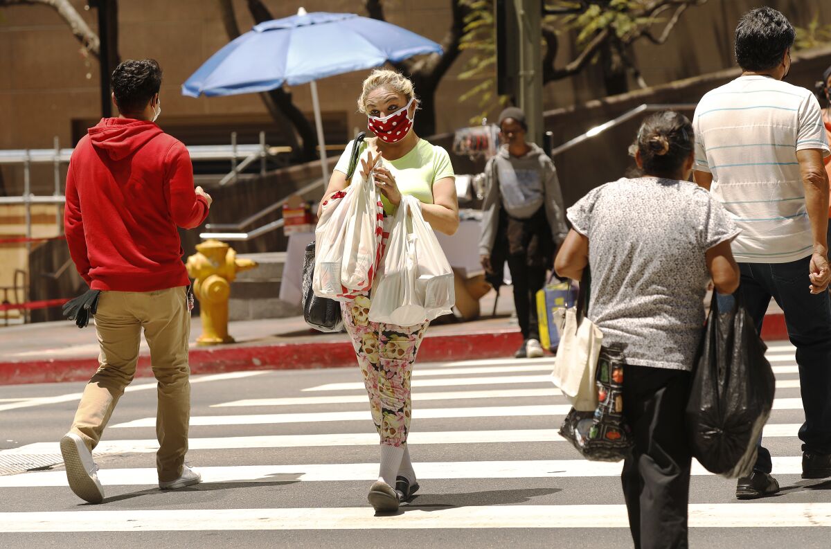Demetria Christ carries her groceries after shopping at FIGat7th