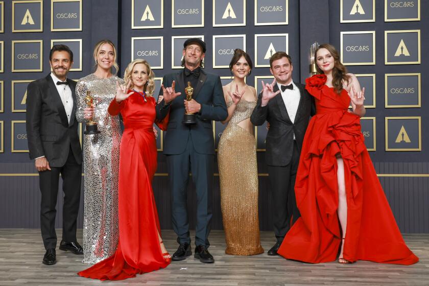 HOLLYWOOD, CA - March 27, 2022. Eugenio Derbez, Sian Heder, Marlee Matlin, Troy Kotsur, Emilia Jones, Daniel Durant and Amy Forsyth, winners of the Best Picture award for ‘CODA’ in the Photo Room during the 94th Academy Awards at the Dolby Theatre at Ovation Hollywood on Sunday, March 27, 2022. (Allen Schaben / Los Angeles Times)