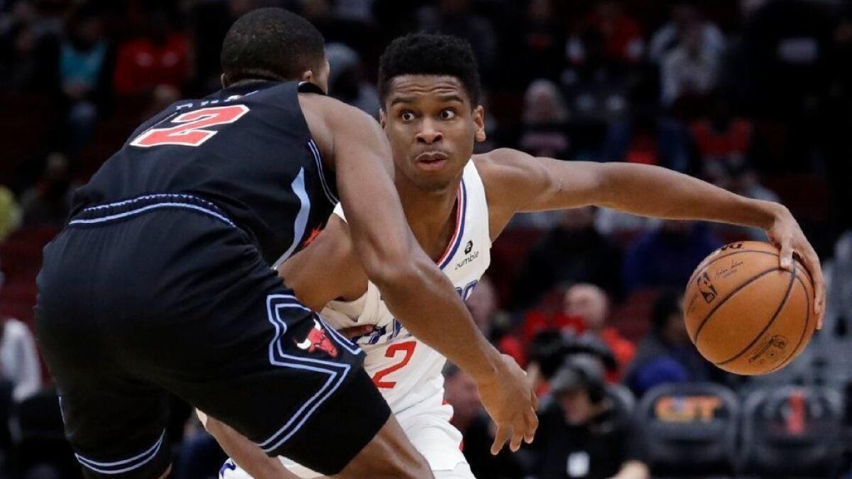 Clippers guard Shai Gilgeous-Alexander, right, controls the ball in front of Chicago Bulls forward Jabari Parker during a game on Jan. 25.
