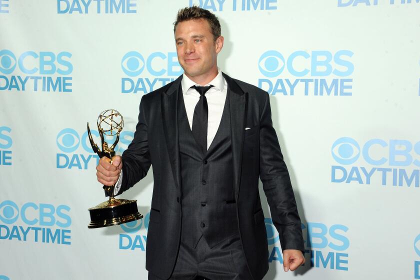 Billy Miller holds his Emmy Award backstage