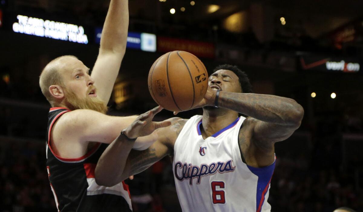 Clippers center DeAndre Jordan is fouled by Trail Blazers center Chris Kaman during a game on March 4.