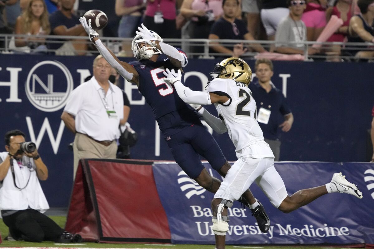 Arizona wide receiver Dorian Singer (5) makes a catch while being defended by Colorado cornerback Nigel Bethel Jr.