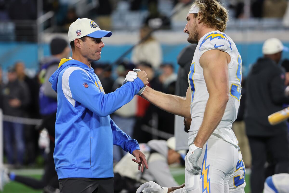 Chargers head coach Brandon Staley greets linebacker Joey Bosa (97) before their wild-card game.