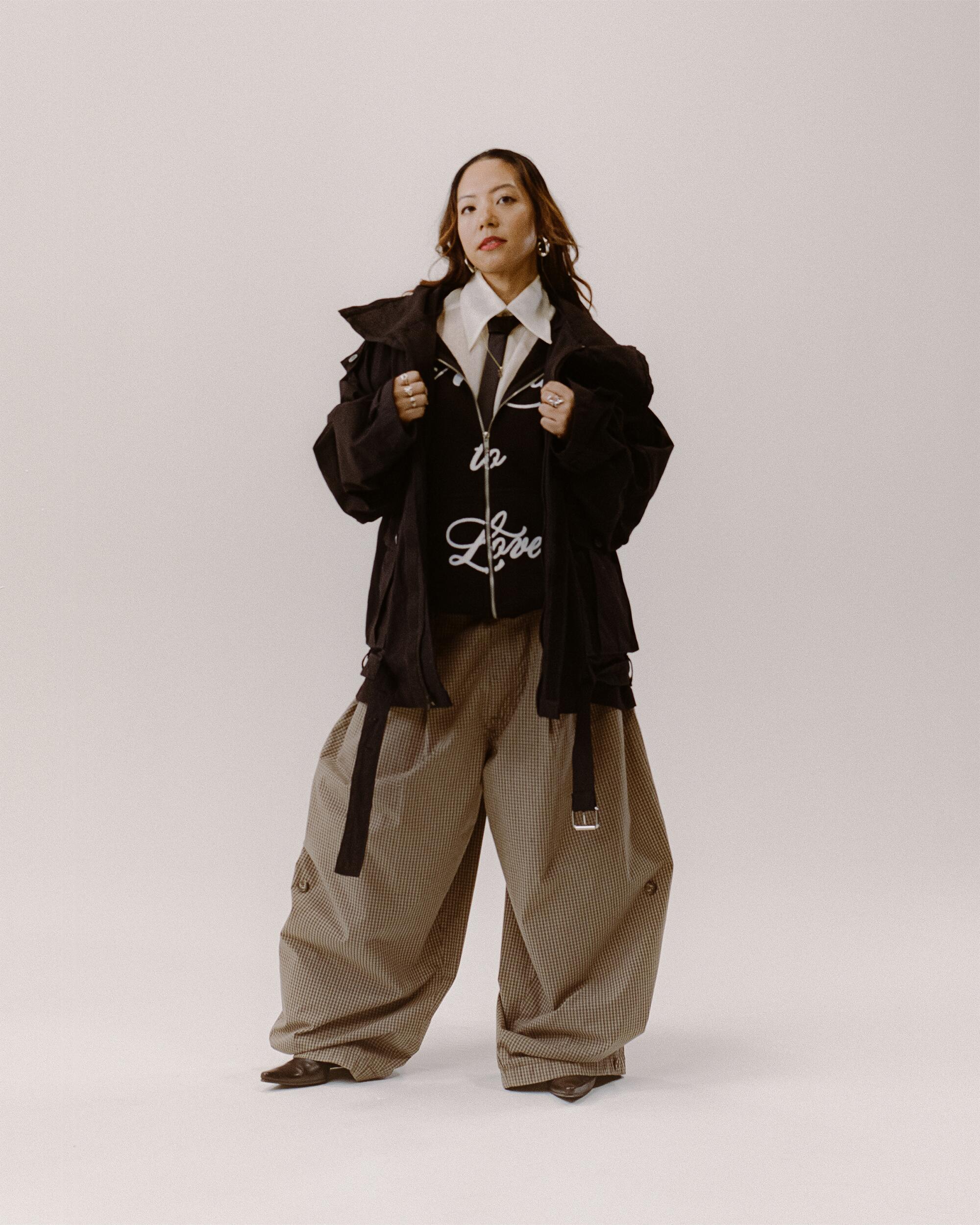 Stephanie wears FAMILY by Coen Clemente Made to Love zip-up, Maaari Pina button-up, Art Community Anorak overgarment and Japanese