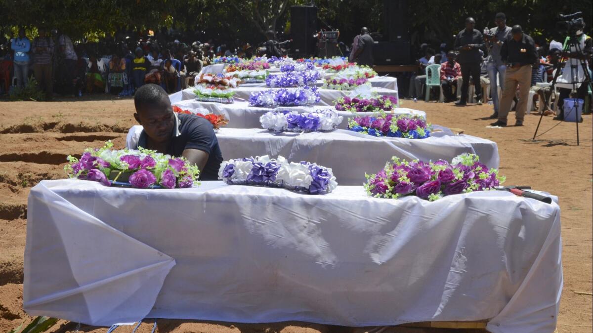 Coffins for some of the victims of the capsized passenger ferry Nyerere are set out during a mass burial ceremony on Ukara Island, Tanzania, on Sunday, Sept. 23, 2018.