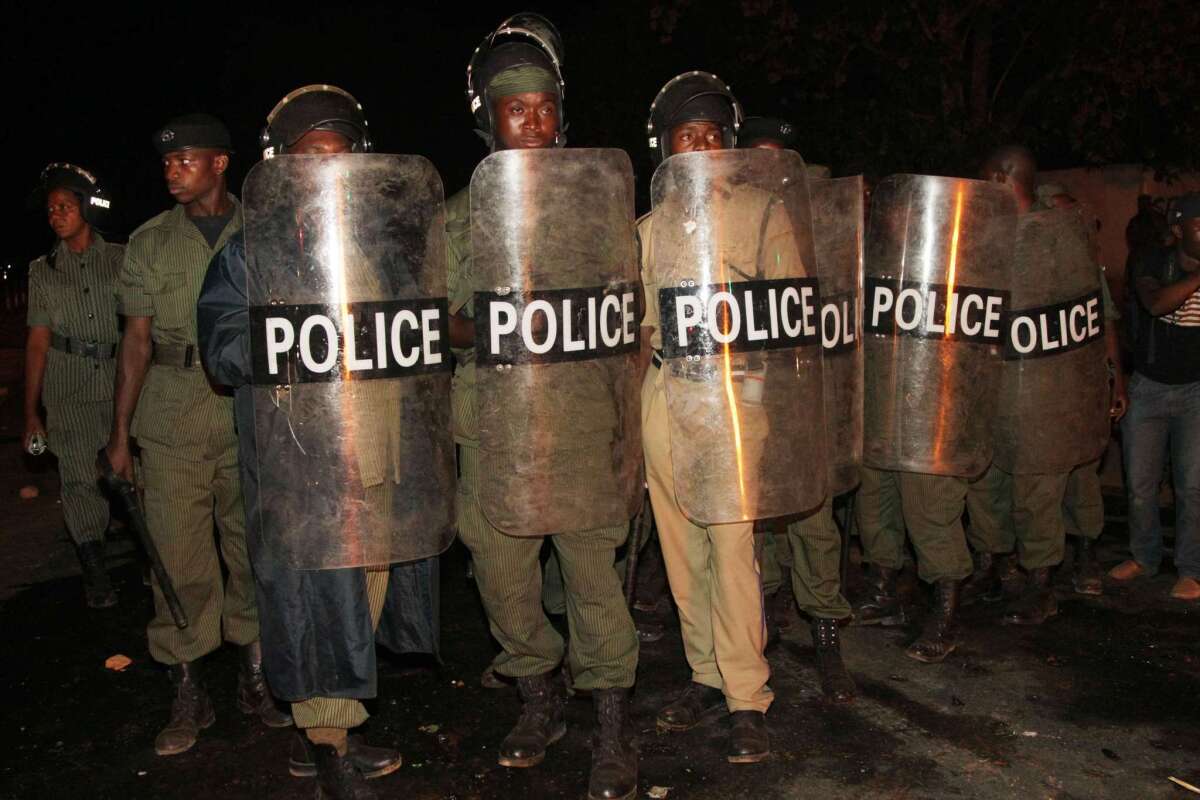 Zambian riot police stand guard after taking control of Lusaka's Belvedere area late Nov. 3.