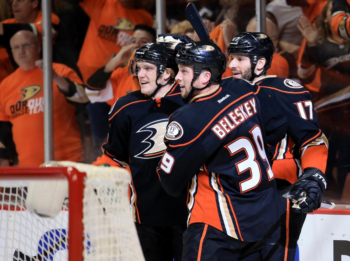 Ducks left wing Matt Beleskey celebrates with teammates Clayton Stoner, left, and Ryan Kesler (17) after scoring against the Flames in the first period of Game 2 on Sunday night.