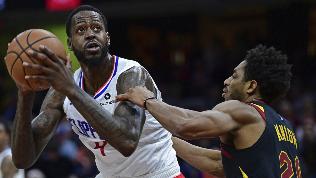 Clippers forward JaMychal Green looks to shoot over Cleveland's Brandon Knight during a game on March 22.
