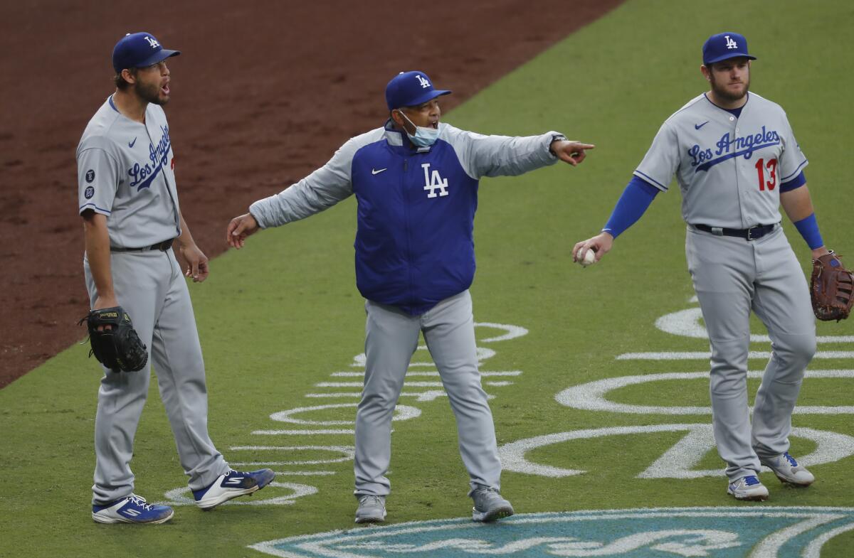 Dodgers pitcher Clayton Kershaw and manager Dave Roberts argue a catcher's interference call.