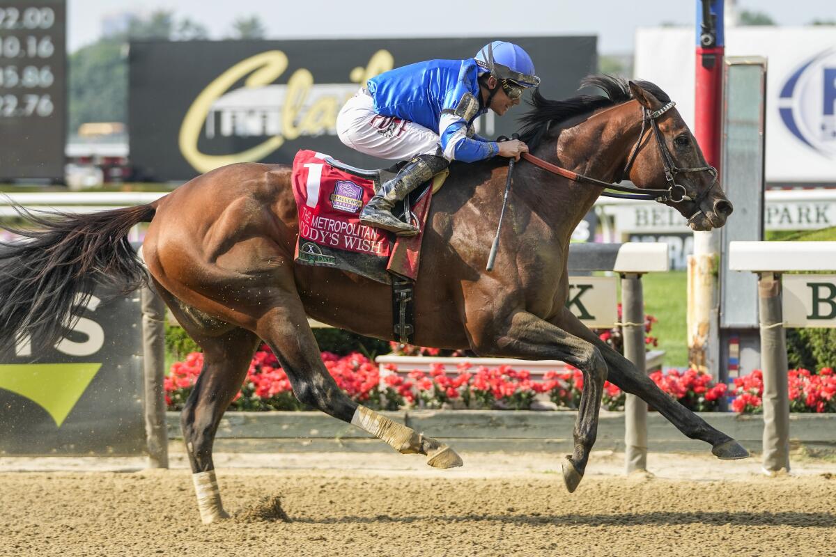 Cody's Wish, with jockey Junior Alvarado aboard, crosses the finish line to win The Hill N' Dale Metropolitan.