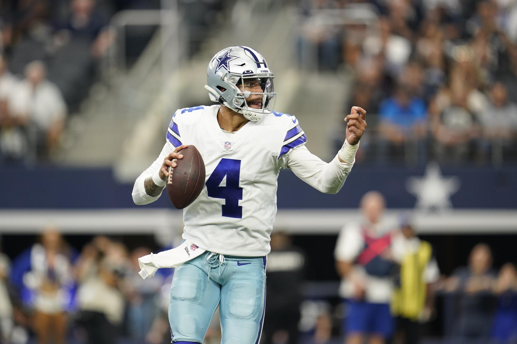 Dallas Cowboys quarterback Dak Prescott motions as he looks to pass against the Carolina Panthers.