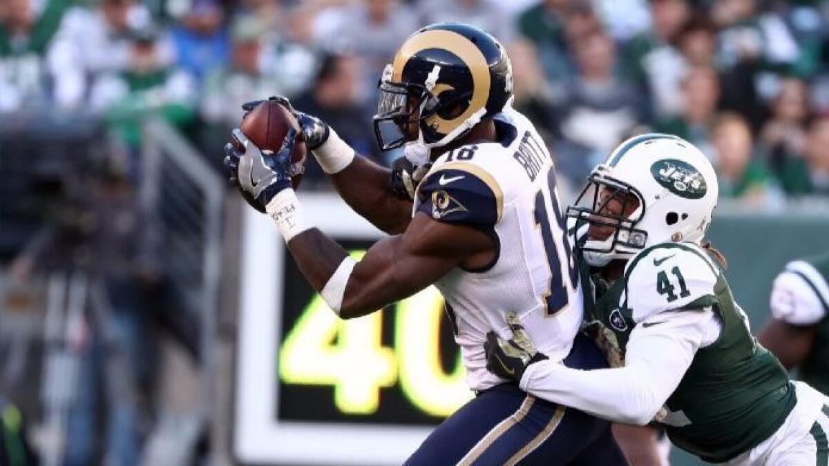 Rams receiver Kenny Britt makes a catch against Jets cornerback Buster Skrine during a game on Nov. 13.