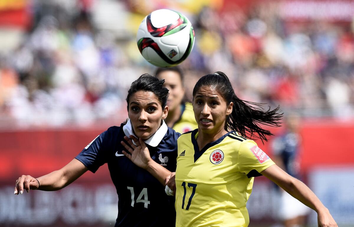 Colombian midfielder Carolina Arias, right, and French midfielder Louisa Necib go after the ball during a Women's World Cup match Saturday at Mocton Stadium.