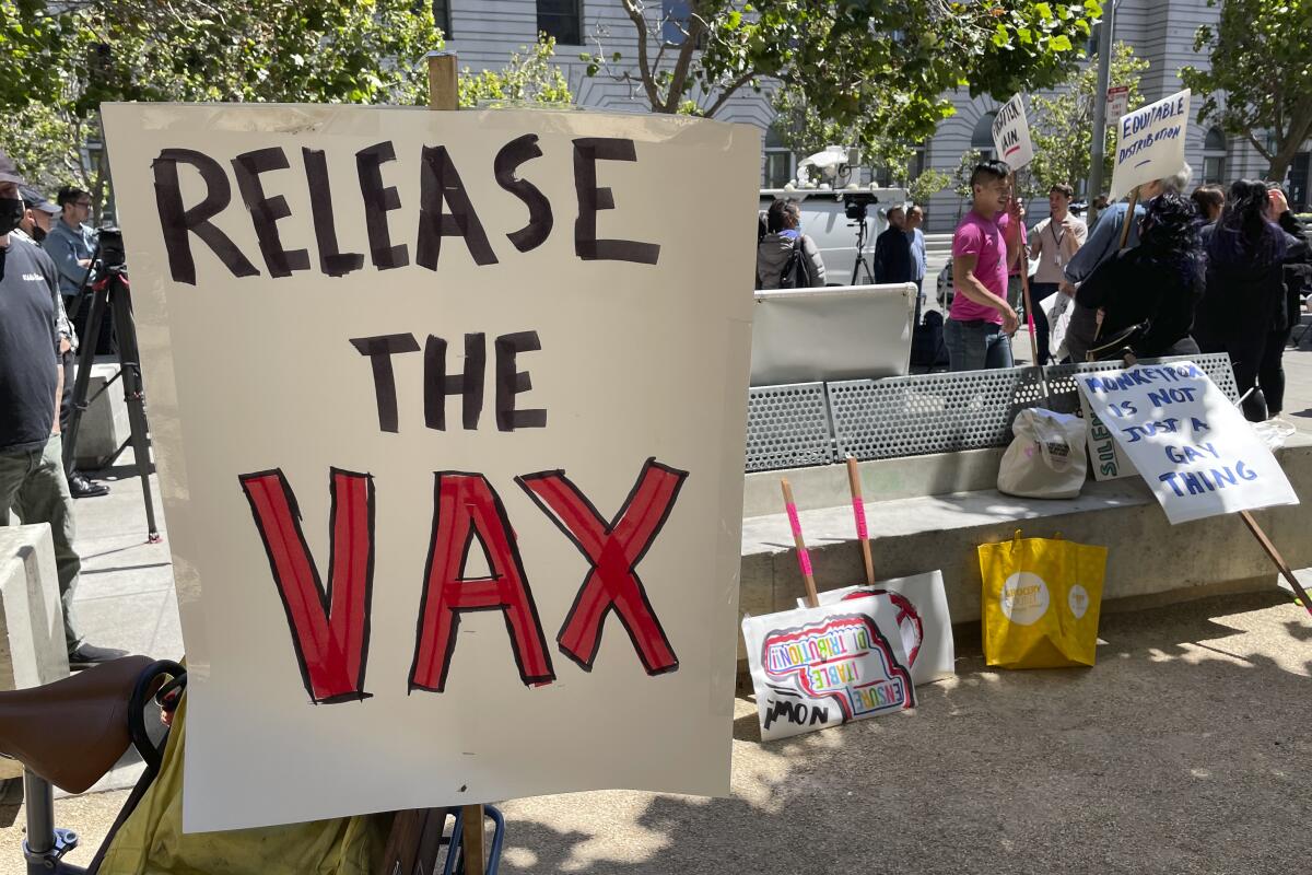 Protesters hold signs including "Release the Vax," referring to the mpox vaccine.