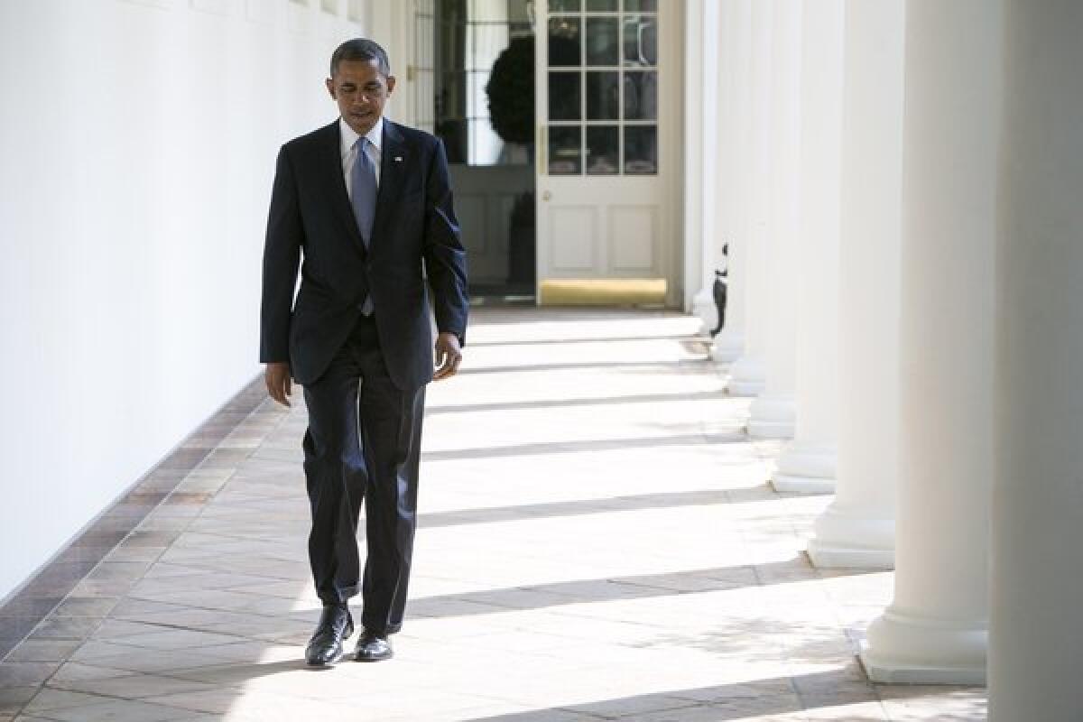 President Obama walks to the Oval Office on Tuesday.