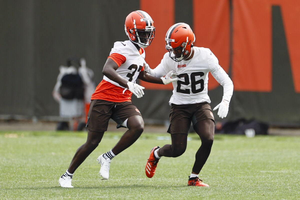 Cleveland Browns cornerback Greedy Williams (26) defends against Emmanuel Rugamba (37) during an NFL football practice at the team's training facility Wednesday, June 9, 2021, in Berea, Ohio. (AP Photo/Ron Schwane)