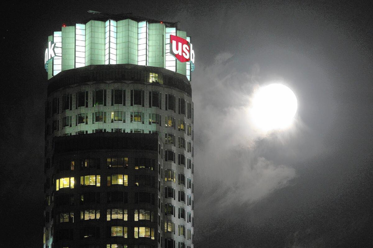 U.S. Bank has been ordered to pay $57 million in refunds and penalties for failing to deliver services it sold to protect customers against identity theft. Above, the bank's name looms large above Los Angeles.