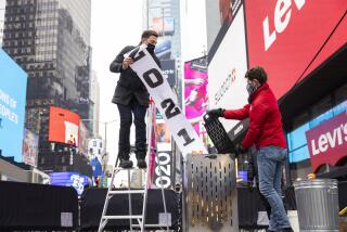 Times Square Alliance burn a 2021 banner in Times Square, Tuesday, Dec. 28, 2021, in New York.
