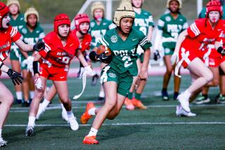 Long Beach Poly's Neela Bagley runs for yardage during a League of Champions girls' flag football game against Redondo Union.