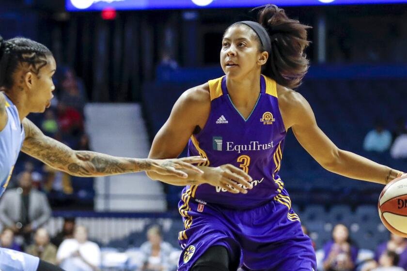 Sparks forward Candace Parker drives the lane against Sky forward Tamera Young during the first half Sunday.