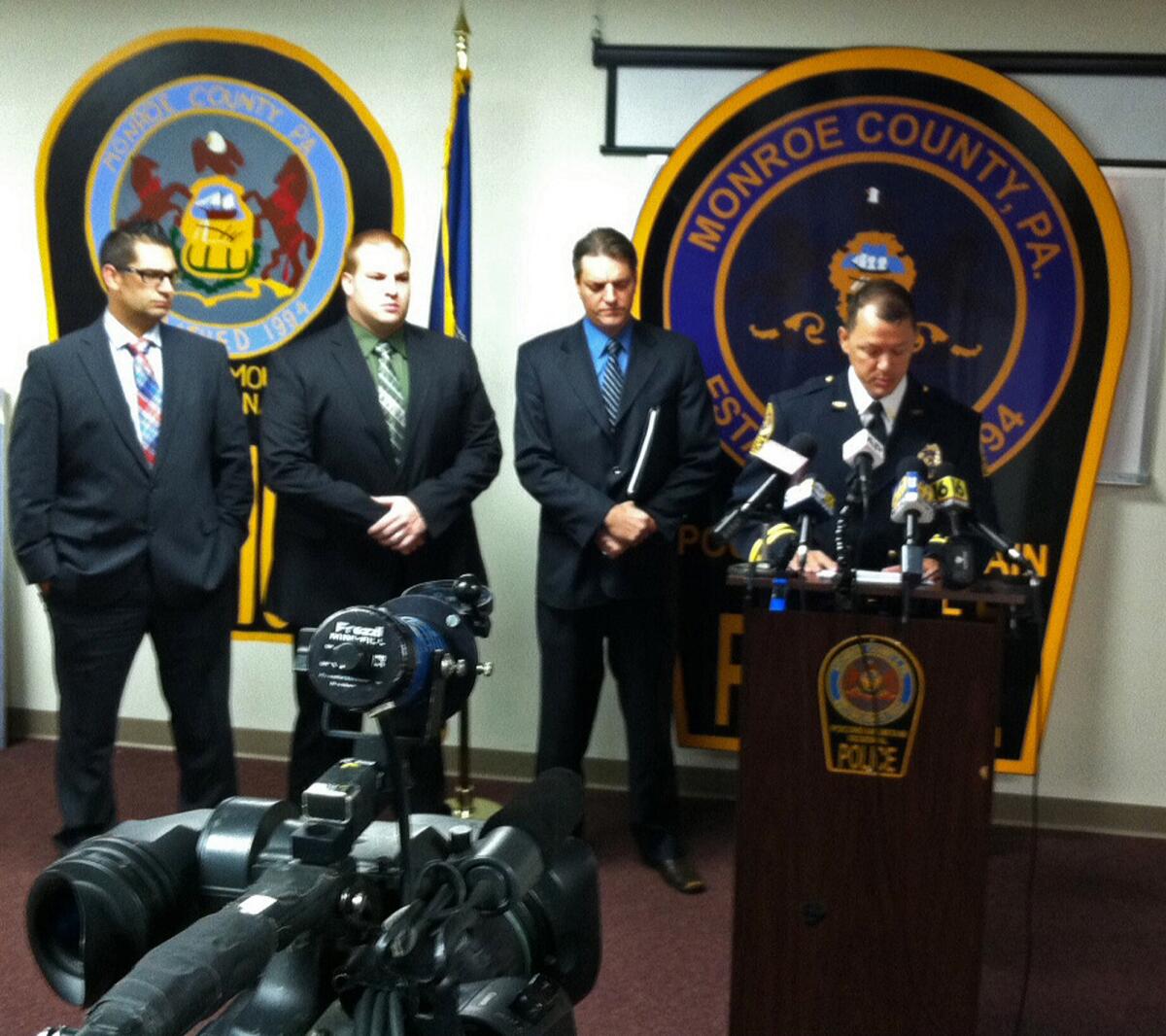 From left, Pocono Mountain Regional Police Department Cpl. Lucas Bray, Det. Robert Miller, Monroe County Assistant Dist. Atty. Michael Rakaczewski and Police Chief Christopher Wagner speak during a Tuesday news conference in Pocono Summit, Pa., about plans to arrest 37 people in the December 2013 death of 19-year-old Chun "Michael" Deng.