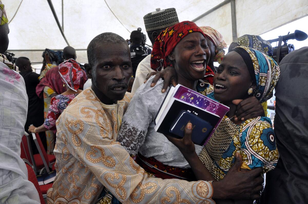A girl that was kidnapped celebrates with family members after her release.