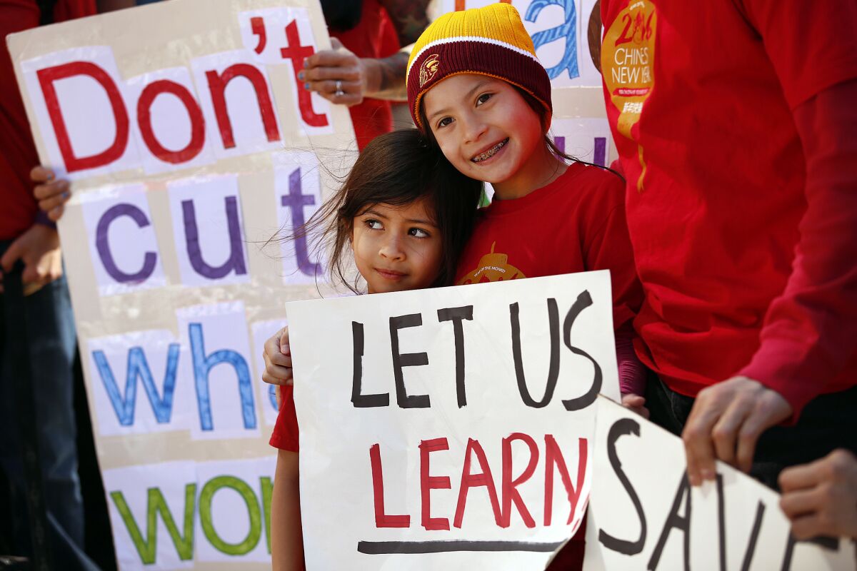 Los Angeles Unified School District students Alexandria Marek, 8, right, and Kerala Seth, 4, left, protested the district's cuts to the high-profile Mandarin Immersion Program at Venice's Broadway Elementary school in March.