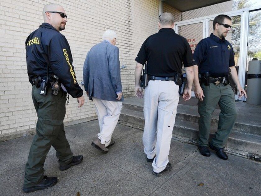 Kaufman County, Texas, law enforcement officials escort an employee into the courthouse. Security remained tight across the state after a second prosecutor was slain.