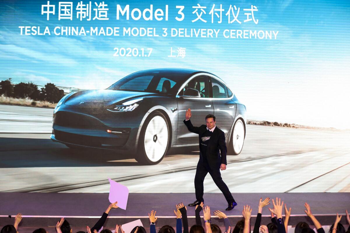 Tesla CEO Elon Musk greets the crowd at a Tesla China-made Model 3 delivery ceremony in Shanghai on Jan. 7.