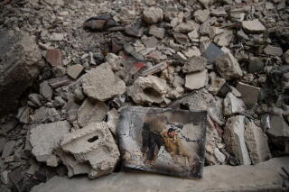 A pile of rubble reflects the damage to the Yarmouk headquarters of the Popular Front for the Liberation of Palestine - General Command.